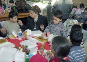 Some of the many Children at the very first Christmas for Refugee dinner receive food and some Christmas joy