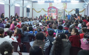 Children react as clown performer announces entrance of another character. More than 300 children attended this event